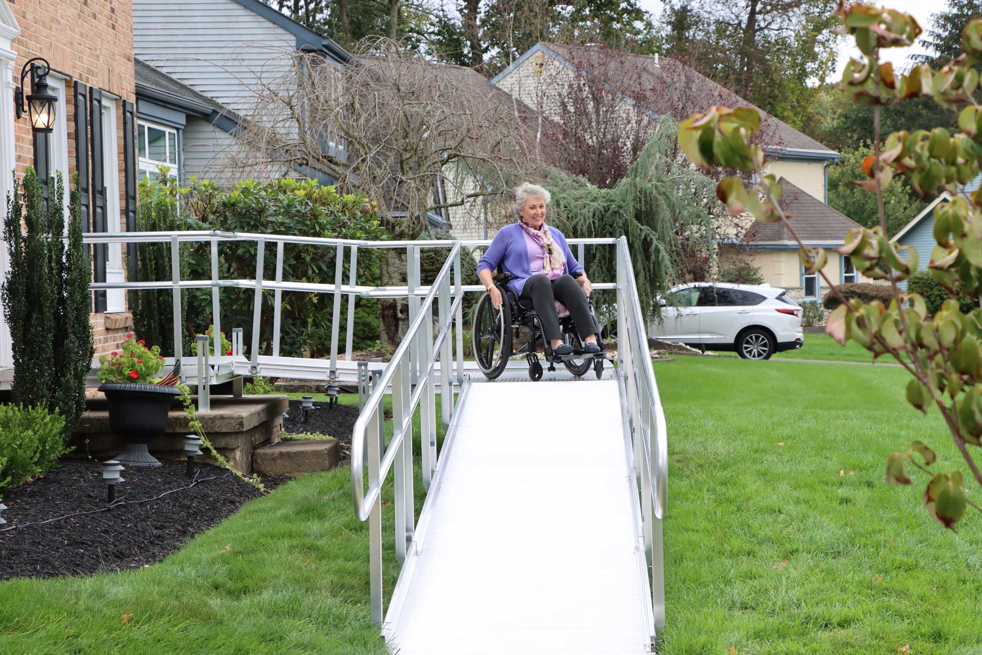 Woman using the ramp with a wheelchair.